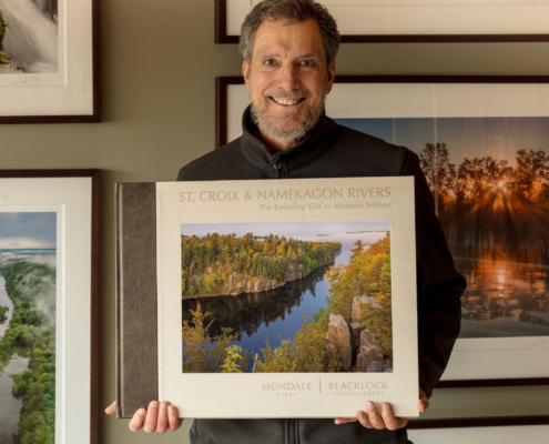 Photographer Craig Blacklock with a copy of his published book