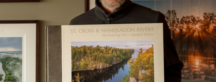 Photographer Craig Blacklock with a copy of his published book